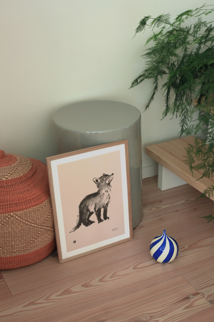 Old rose fox cub poster on a wooden frame on a floor